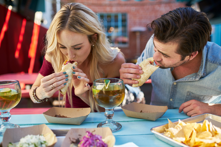 Vrouw en man eten een wrap